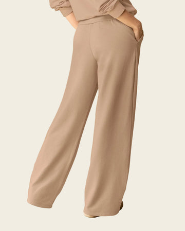 Pantalón ruedo amplio con elástico y tira anudable en cintura#color_c54-arena