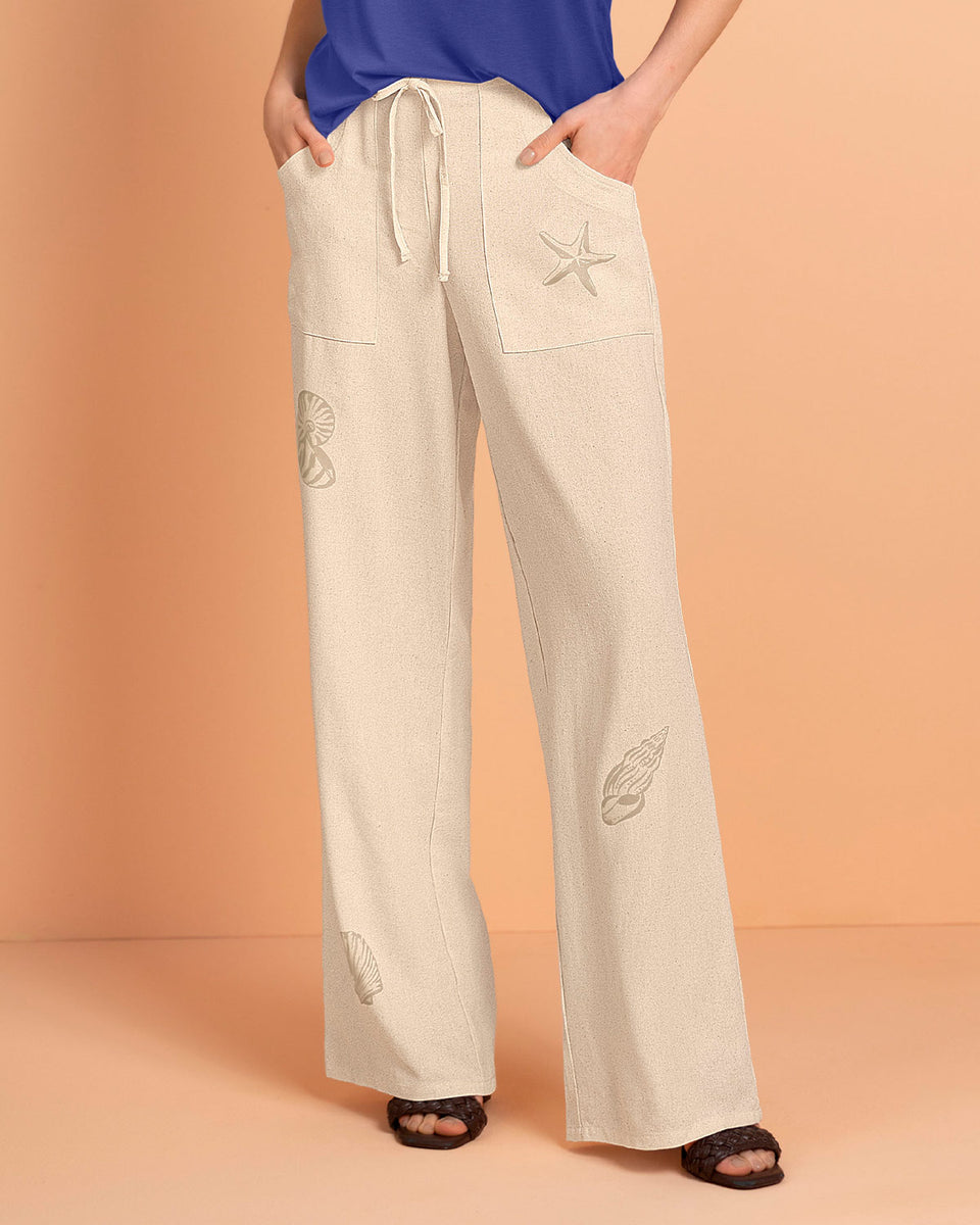 Pantalón ruedo ancho en tela tipo lino con estampado localizado